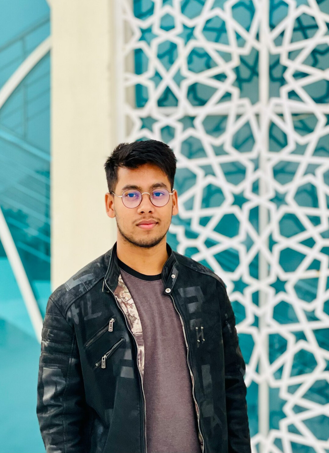 Portrait of a Malaysian software engineer smiling in an office